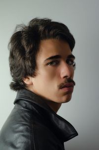 Portrait of young man against white background