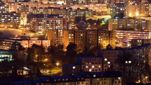 High angle view of illuminated buildings in city at night