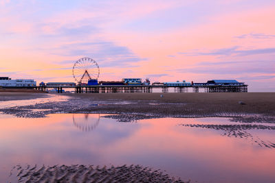 Pier over sea against sky during sunset