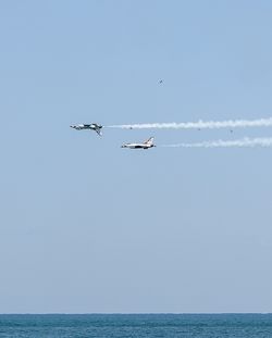 Boats in sea against sky