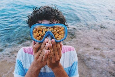 Close-up of boy on sand at beach