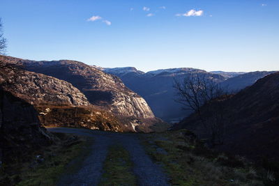 Road amidst mountains against sky