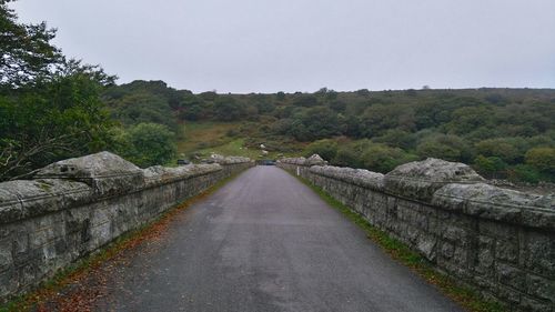 Empty road along countryside landscape