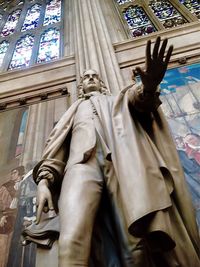 Low angle view of statue against building