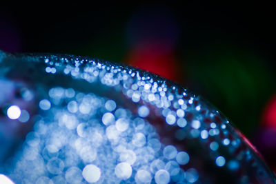 Close-up of waterdrops on blurred umbrella