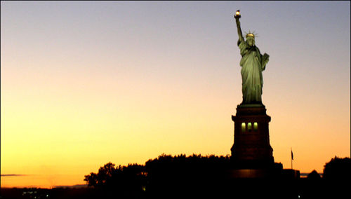 Low angle view of statue of liberty against clear sky