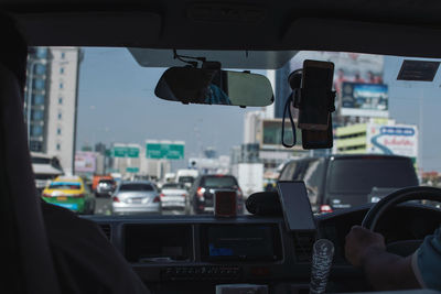 Cropped image of people traveling in car