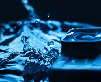 High angle view of water splashing on glass