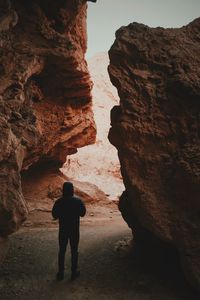 Person standing by rock