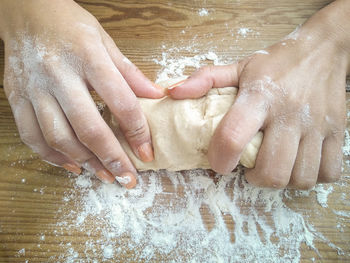 High angle view of hands preparing food