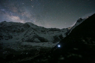 Scenic view of mountains against sky at night