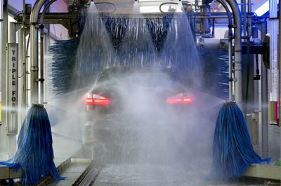 Water spraying on vehicle at car wash