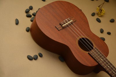 Close-up of guitar and pebbles on table