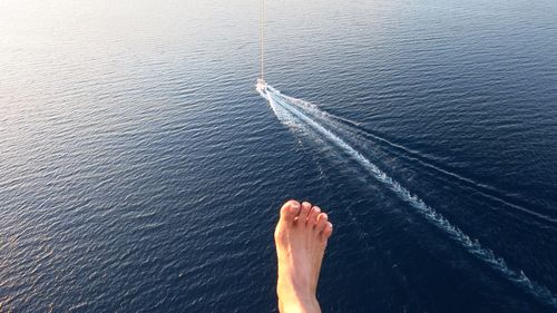 Low section of person on boat in sea