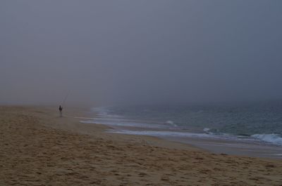 Scenic view of beach against clear sky