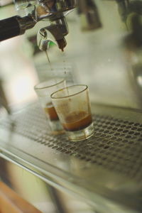 Close-up of coffee pouring in glass