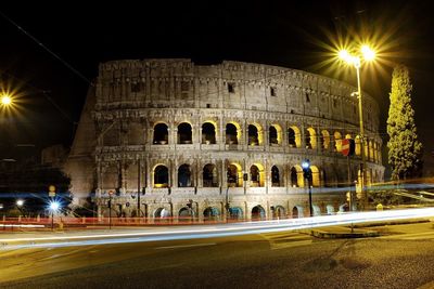 Low angle view of illuminated building against sky at night