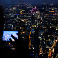 Aerial view of illuminated cityscape against sky at night