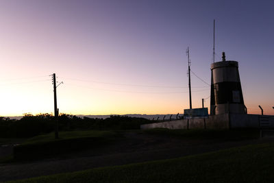 Wind turbines on field at sunset