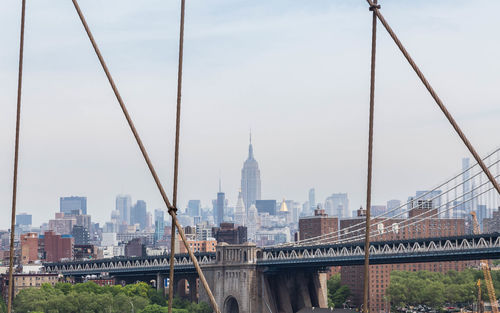 Steel cables of bridge with buildings in backgrounds