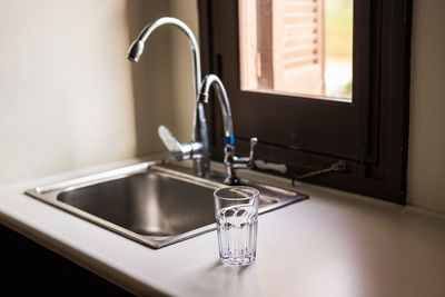 Close-up of faucet in bathroom