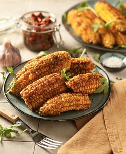 Grilled sweet corn with spices on the plates