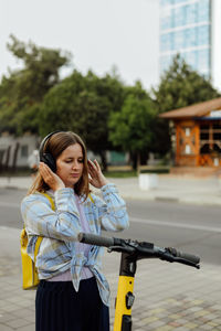 Portrait of young woman standing on street