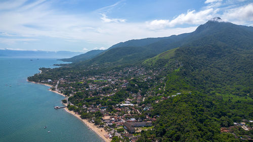 High angle view of townscape by sea against sky