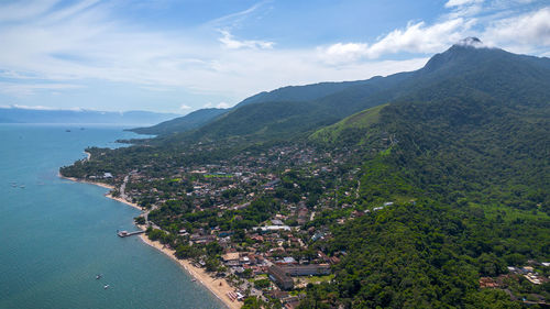 High angle view of townscape by sea against sky