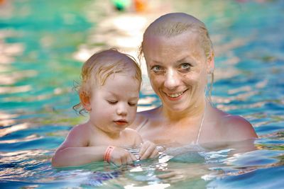 Portrait of smiling boy swimming in pool