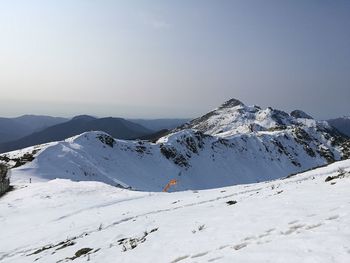 Scenic view of snowcapped mountains against clear sky