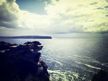 Scenic view of sea against cloudy sky