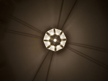 Low angle view of illuminated pendant lights hanging from ceiling