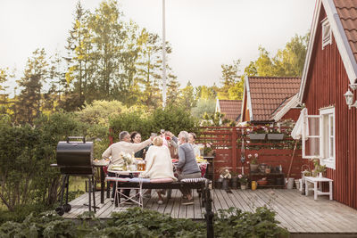 People relaxing on table against plants