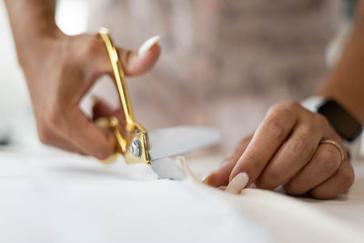 Cropped hand of woman holding dentures