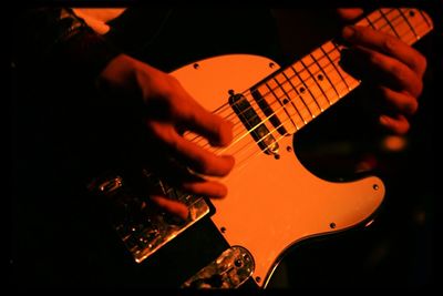 Cropped image of man playing guitar