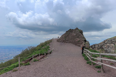 Footpath by sea against sky