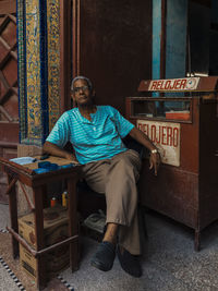 Portrait of man sitting on table