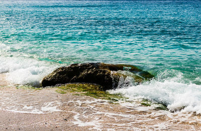 High angle view of sea waves splashing on shore