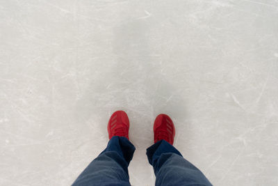 Low section of person standing on snow