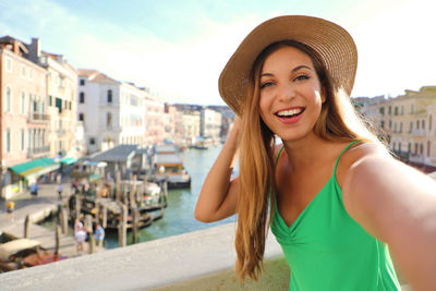 Portrait of smiling young woman in city