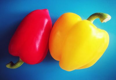 High angle view of bell peppers against blue background