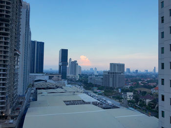 Buildings in city against clear sky