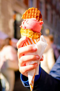 Midsection of woman holding ice cream cone