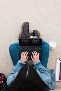 Top view of a university student while she writes in her laptop