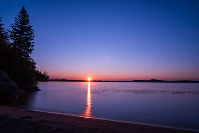 Scenic view of sea against clear sky during sunset