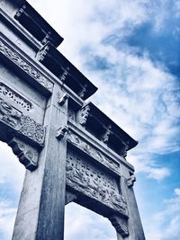 Low angle view of historical building against cloudy sky