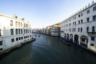 View of canal amidst buildings in city