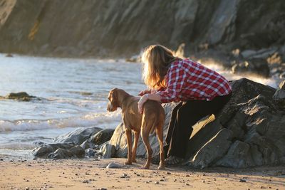 Woman with dog on beach
