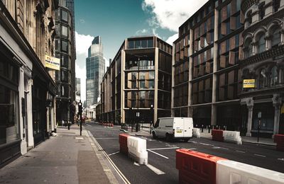 City street amidst buildings against sky